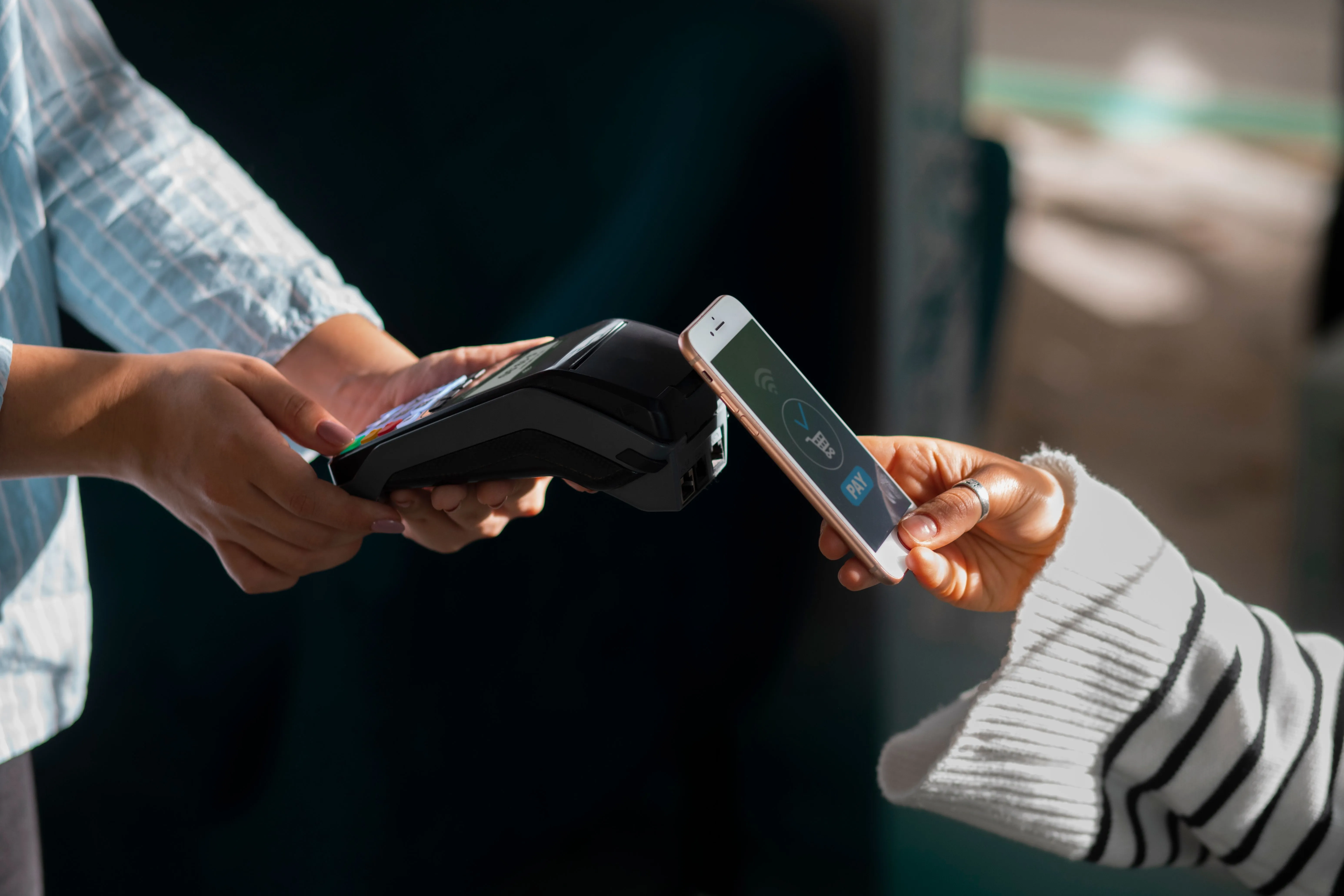 Tapping a phone against a handheld card machine