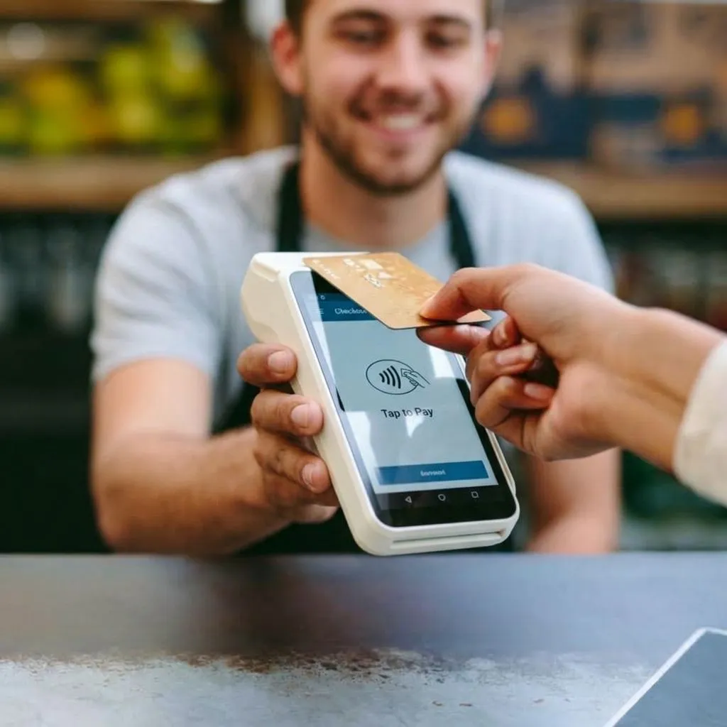 A customer paying with a handheld card machine